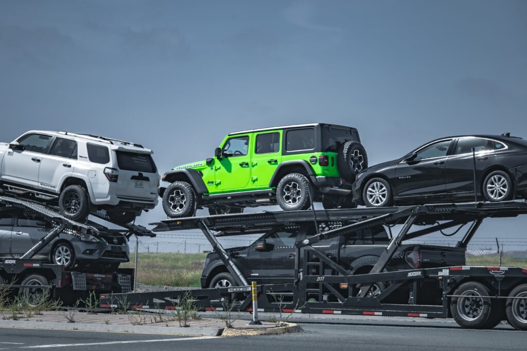 Multi-car transport trailer with five vehicles loaded—long-distance towing. Long-distance car towing is a safe and convenient way to move vehicles nationwide. Our Car towing services are available in all 50 states.
