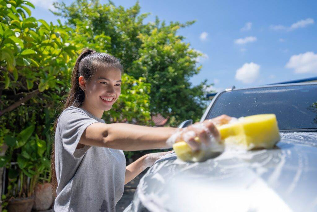 Girl washing her car.